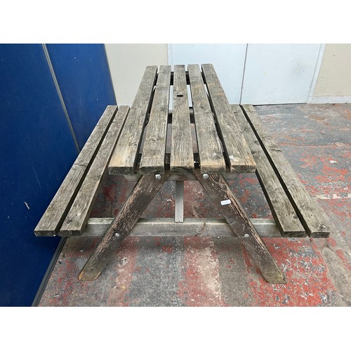 122 - A wooden picnic bench - approx. 75cm high x 127cm wide x 149cm long