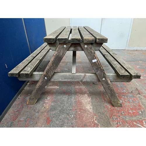 122 - A wooden picnic bench - approx. 75cm high x 127cm wide x 149cm long