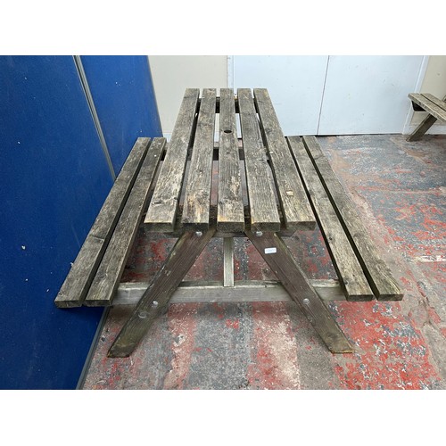 129 - A wooden picnic bench - approx. 75cm high x 127cm wide x 149cm long