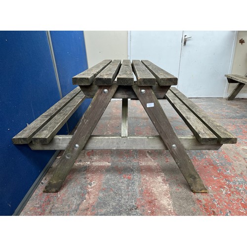 129 - A wooden picnic bench - approx. 75cm high x 127cm wide x 149cm long