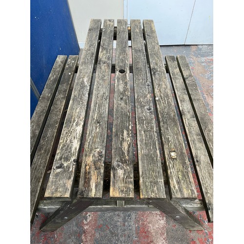 129 - A wooden picnic bench - approx. 75cm high x 127cm wide x 149cm long