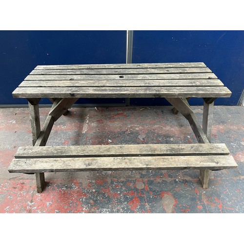 130 - A wooden picnic bench - approx. 75cm high x 127cm wide x 149cm long