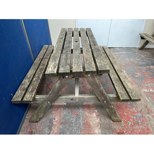 130 - A wooden picnic bench - approx. 75cm high x 127cm wide x 149cm long