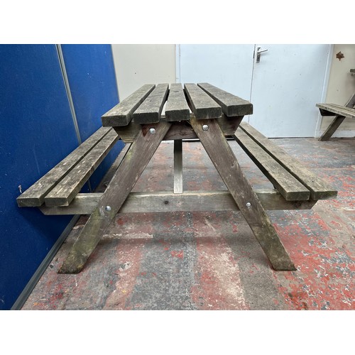 130 - A wooden picnic bench - approx. 75cm high x 127cm wide x 149cm long