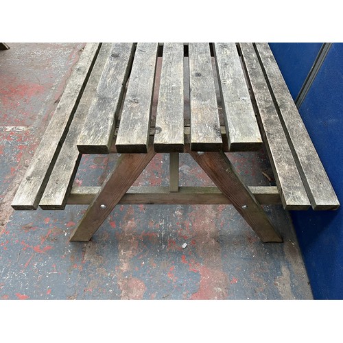 130 - A wooden picnic bench - approx. 75cm high x 127cm wide x 149cm long