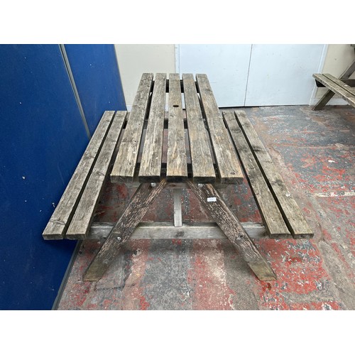 128 - A wooden picnic bench - approx. 75cm high x 127cm wide x 149cm long