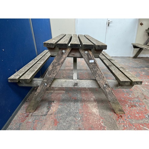 128 - A wooden picnic bench - approx. 75cm high x 127cm wide x 149cm long