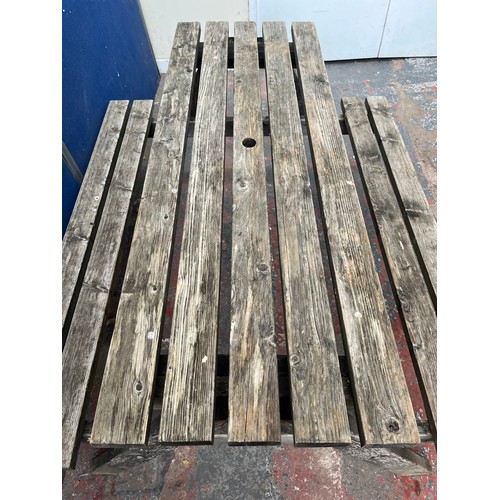 128 - A wooden picnic bench - approx. 75cm high x 127cm wide x 149cm long