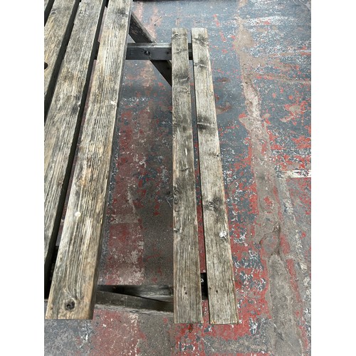 128 - A wooden picnic bench - approx. 75cm high x 127cm wide x 149cm long