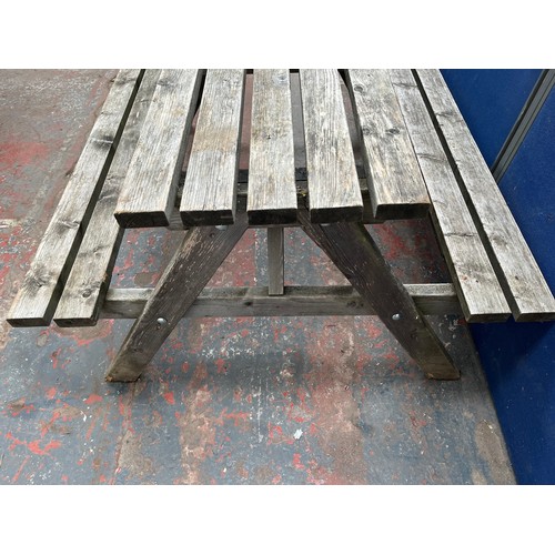 128 - A wooden picnic bench - approx. 75cm high x 127cm wide x 149cm long