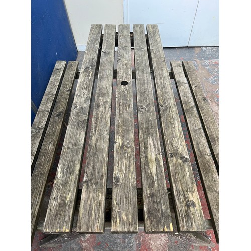 127 - A wooden picnic bench - approx. 75cm high x 127cm wide x 149cm long