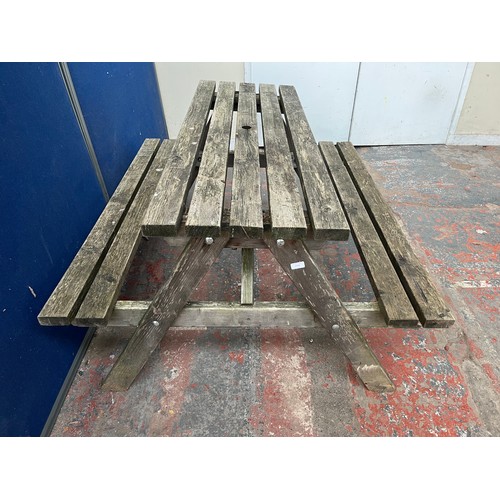 125 - A wooden picnic bench - approx. 75cm high x 127cm wide x 149cm long