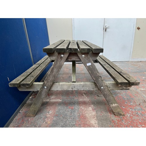 125 - A wooden picnic bench - approx. 75cm high x 127cm wide x 149cm long