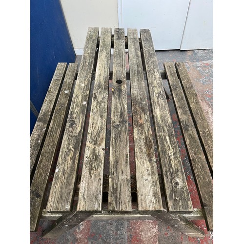 125 - A wooden picnic bench - approx. 75cm high x 127cm wide x 149cm long