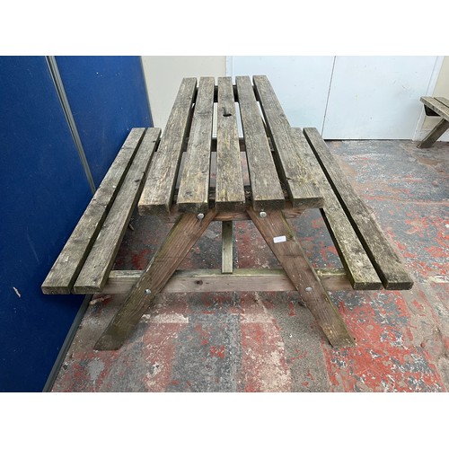 124 - A wooden picnic bench - approx. 75cm high x 127cm wide x 149cm long