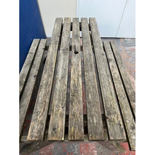 124 - A wooden picnic bench - approx. 75cm high x 127cm wide x 149cm long