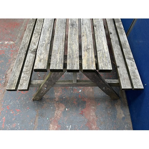 124 - A wooden picnic bench - approx. 75cm high x 127cm wide x 149cm long