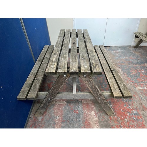 126 - A wooden picnic bench - approx. 75cm high x 127cm wide x 149cm long