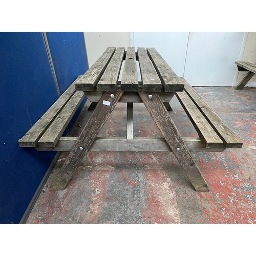 126 - A wooden picnic bench - approx. 75cm high x 127cm wide x 149cm long