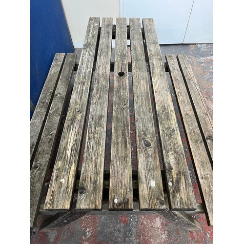 126 - A wooden picnic bench - approx. 75cm high x 127cm wide x 149cm long