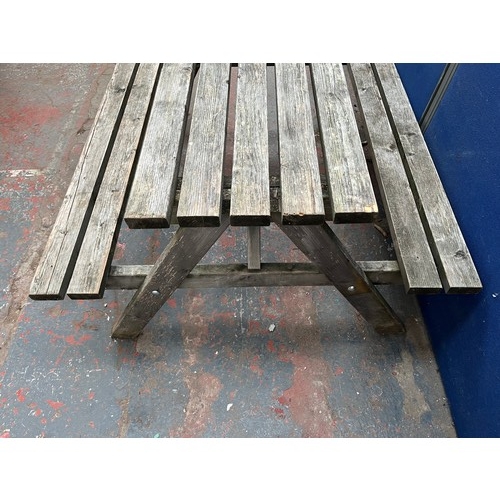 126 - A wooden picnic bench - approx. 75cm high x 127cm wide x 149cm long