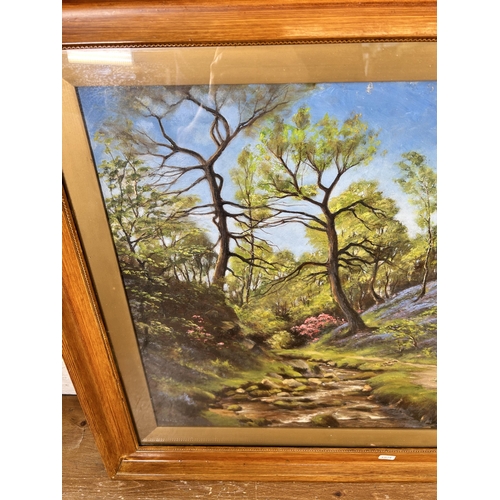 198 - An early 20th century framed oil painting of a woodland scene, signed lower left - approx. 65cm high... 