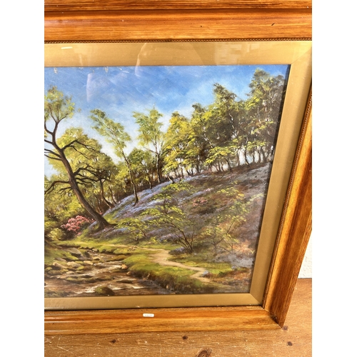 198 - An early 20th century framed oil painting of a woodland scene, signed lower left - approx. 65cm high... 