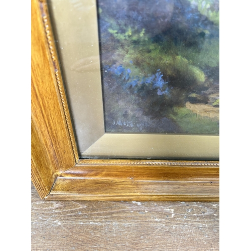 198 - An early 20th century framed oil painting of a woodland scene, signed lower left - approx. 65cm high... 