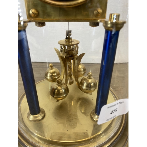 556 - An early 20th century blue enamel and brass 400-day German Torsion mantel clock with glass dome