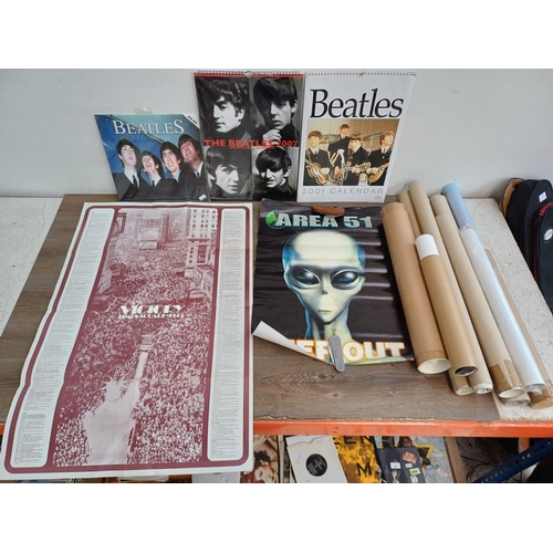 711A - A collection of The Beatles calendars and posters to include 'Victory Times Square 1945', 'Area 51 K... 