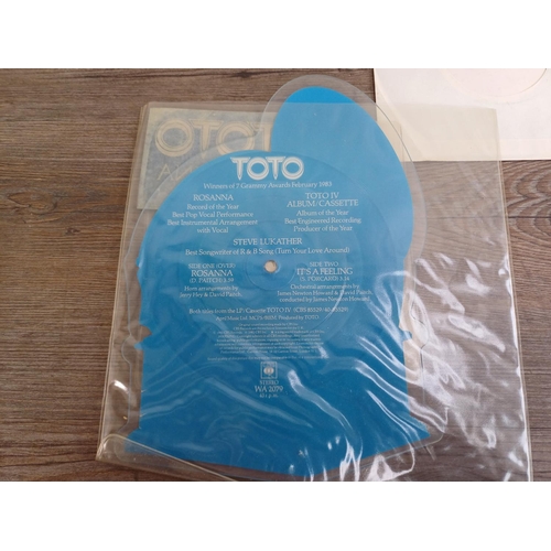 719 - Three vinyl singles, one Toto 'Rosanna' shaped picture disc (WA 2079), one Andrew Matheson 'True Rom... 