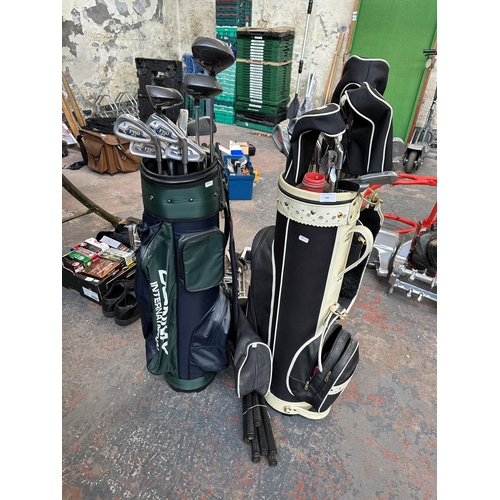 793 - A large collection of golfing equipment to include clubs, two club bags etc.