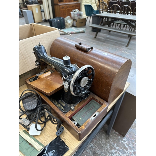 743 - A cased 1930 Singer 66K electric sewing machine with foot pedal, boxed attachments and instruction m... 