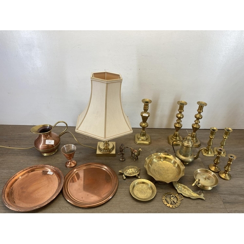 335 - A collection of copper and brassware to include a pair of 25cm brass candlesticks, brass table lamp,... 