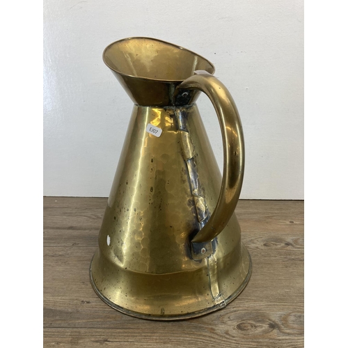 338 - A Victorian brass tapered water jug - approx. 40cm high x 31cm diameter to base