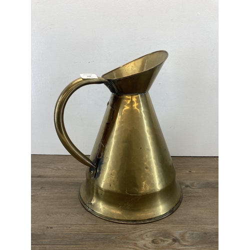 338 - A Victorian brass tapered water jug - approx. 40cm high x 31cm diameter to base