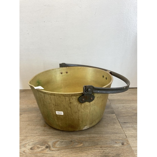 352 - Three pieces of brassware, two 19th century brass preserve pans - largest approx. 16cm high x 31.5cm... 