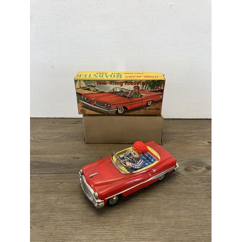 372 - Three mid 20th century tin plate model vehicles, Japanese Honk-Along Roadster, Tri-ang Minic Fire Ch... 