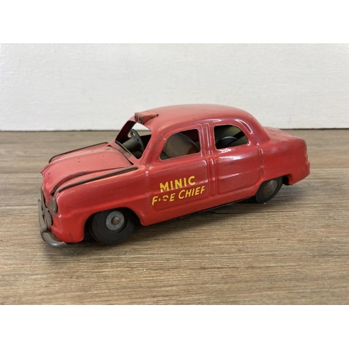 372 - Three mid 20th century tin plate model vehicles, Japanese Honk-Along Roadster, Tri-ang Minic Fire Ch... 