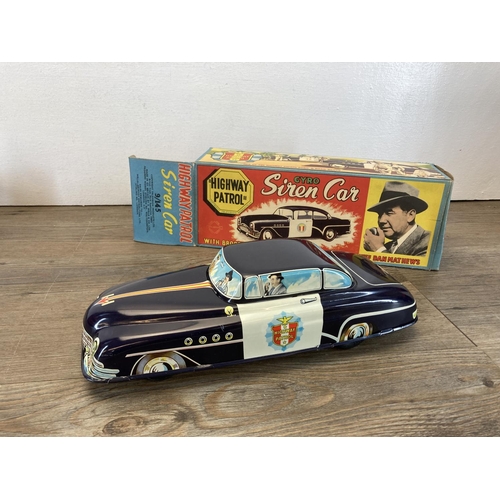 375 - Three mid 20th century tin plate model vehicles, two Brimtoy Highway Patrol friction drive police ca... 