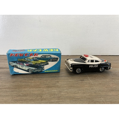 375 - Three mid 20th century tin plate model vehicles, two Brimtoy Highway Patrol friction drive police ca... 