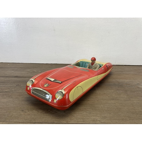 376 - A mid 20th century tin plate West German convertible car with driver, number plate H-X400 - approx. ... 