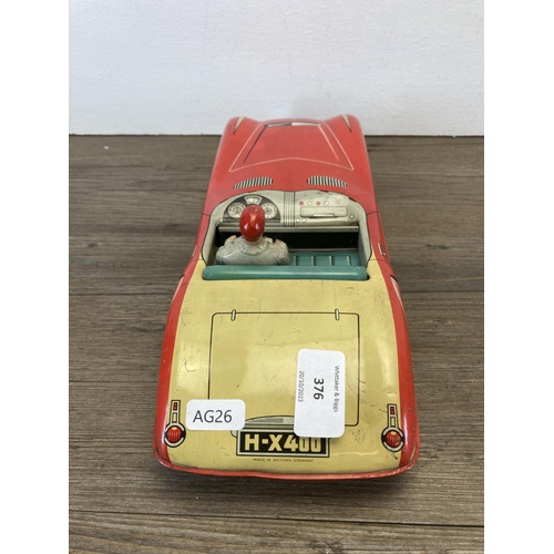 376 - A mid 20th century tin plate West German convertible car with driver, number plate H-X400 - approx. ... 