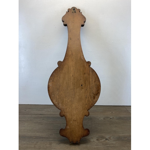 581 - A 19th century carved oak aneroid barometer - approx. 88cm high