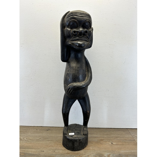 584 - A Maori carved hardwood statue - approx. 62cm high