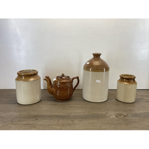 283 - Four ceramic items, two salt glazed stoneware storage jars, one salt glazed stoneware flagon and one... 