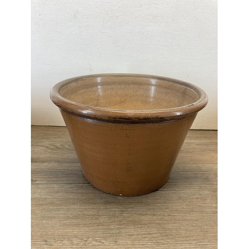 319 - Four salt glazed stoneware dairy bowls - largest approx. 26cm diameter