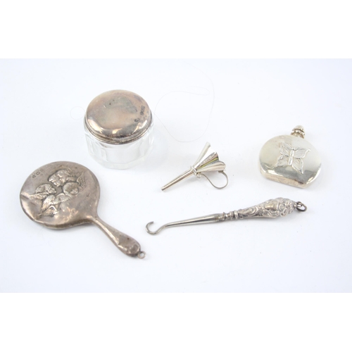 2296 - Five hallmarked sterling silver vanity items to include scent bottle with butterfly design, button h... 