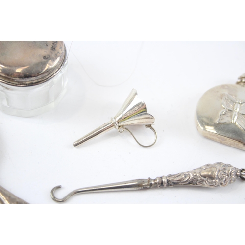 2296 - Five hallmarked sterling silver vanity items to include scent bottle with butterfly design, button h... 