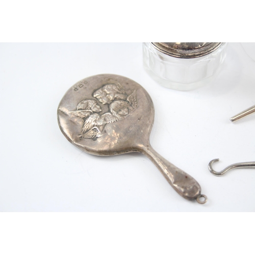 2296 - Five hallmarked sterling silver vanity items to include scent bottle with butterfly design, button h... 